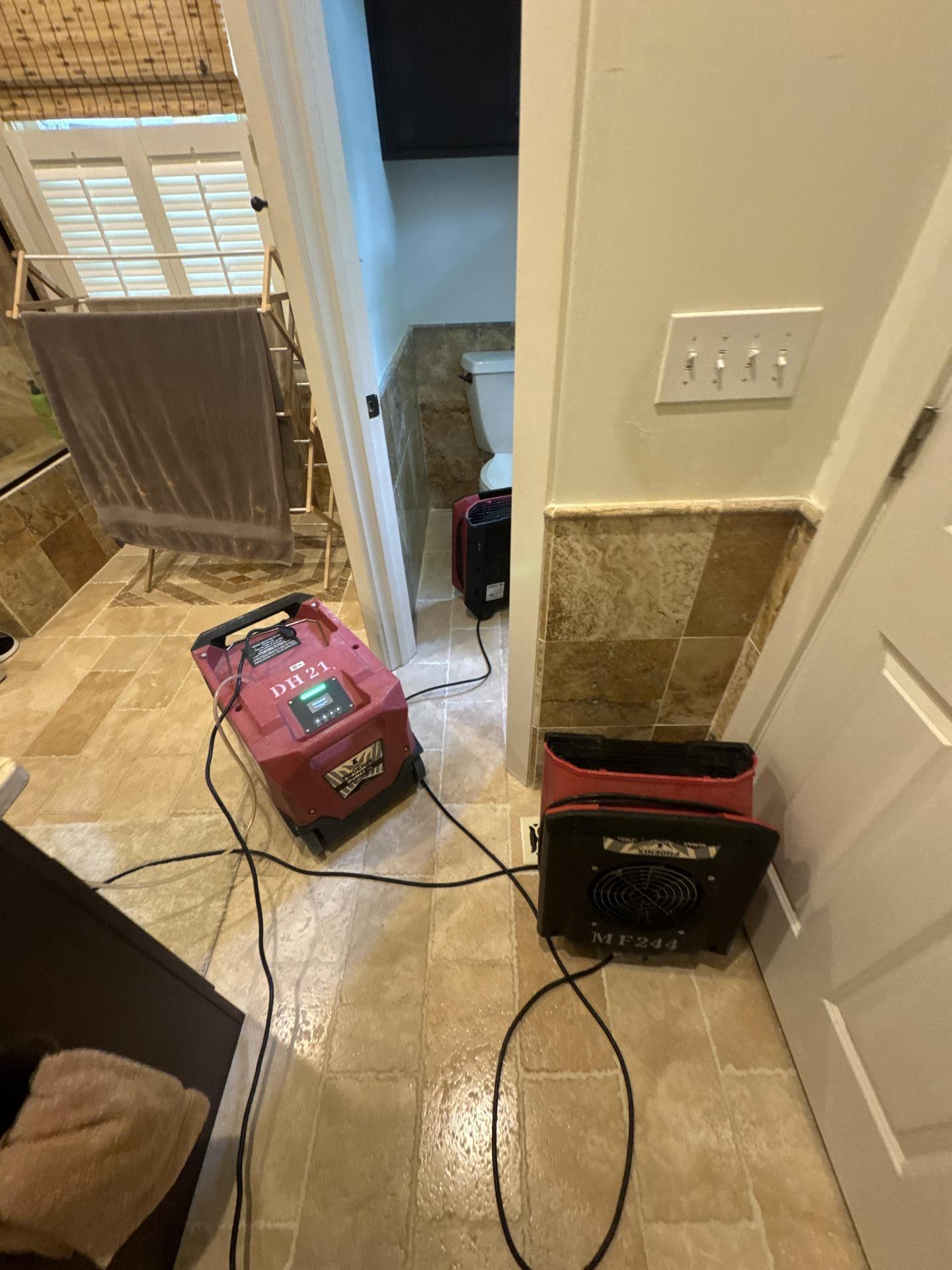 Professional structural drying equipment operating during a residential water damage mitigation project